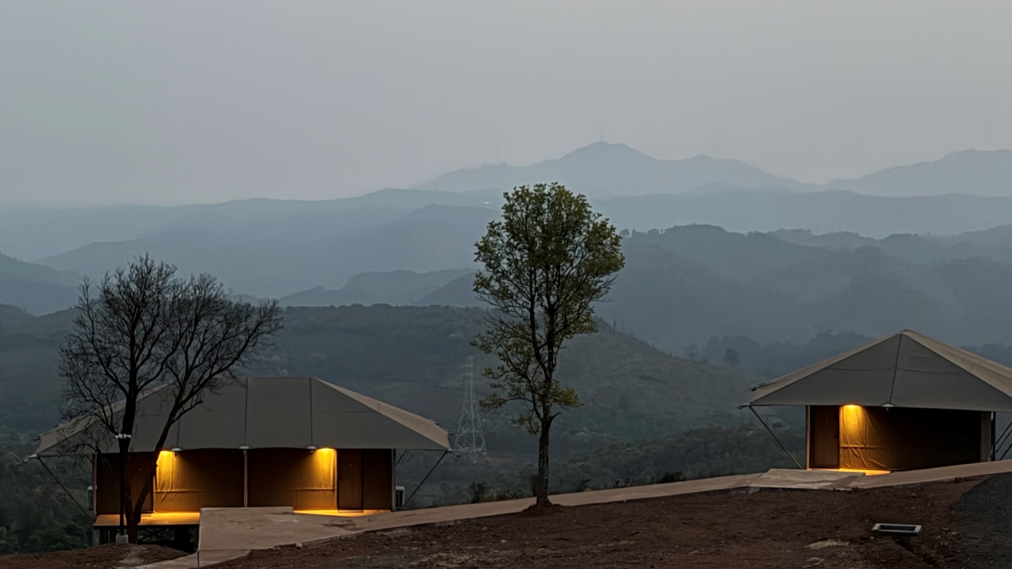HAKSA Hotel lodges illuminated at dusk in the mountains of southern Lao PDR